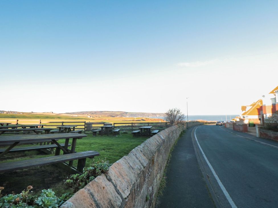 An outdoor scene with tables near the ocean at Beachcrest in Whitby