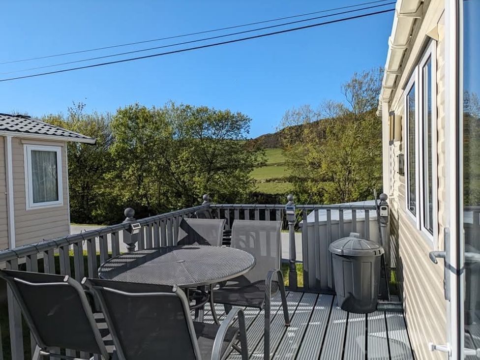 An outdoor area with a table and chairs at Clarach Bay Holiday Village W18 in Aberystwyth