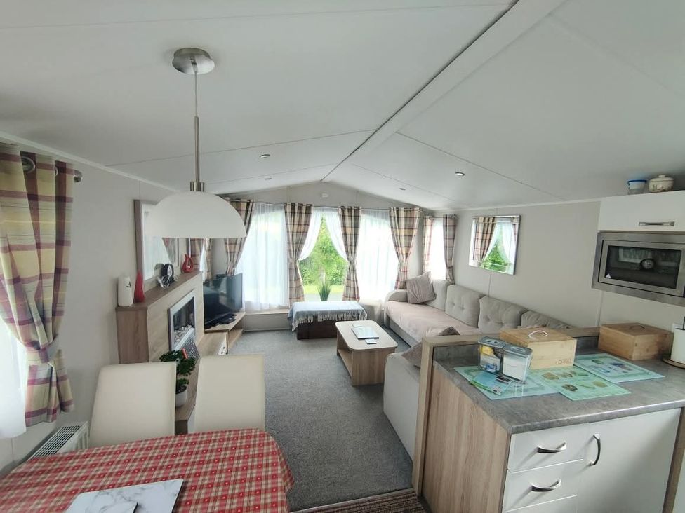 A living room with a sofa and television at Clarach Bay Holiday Village W18 Aberystwyth