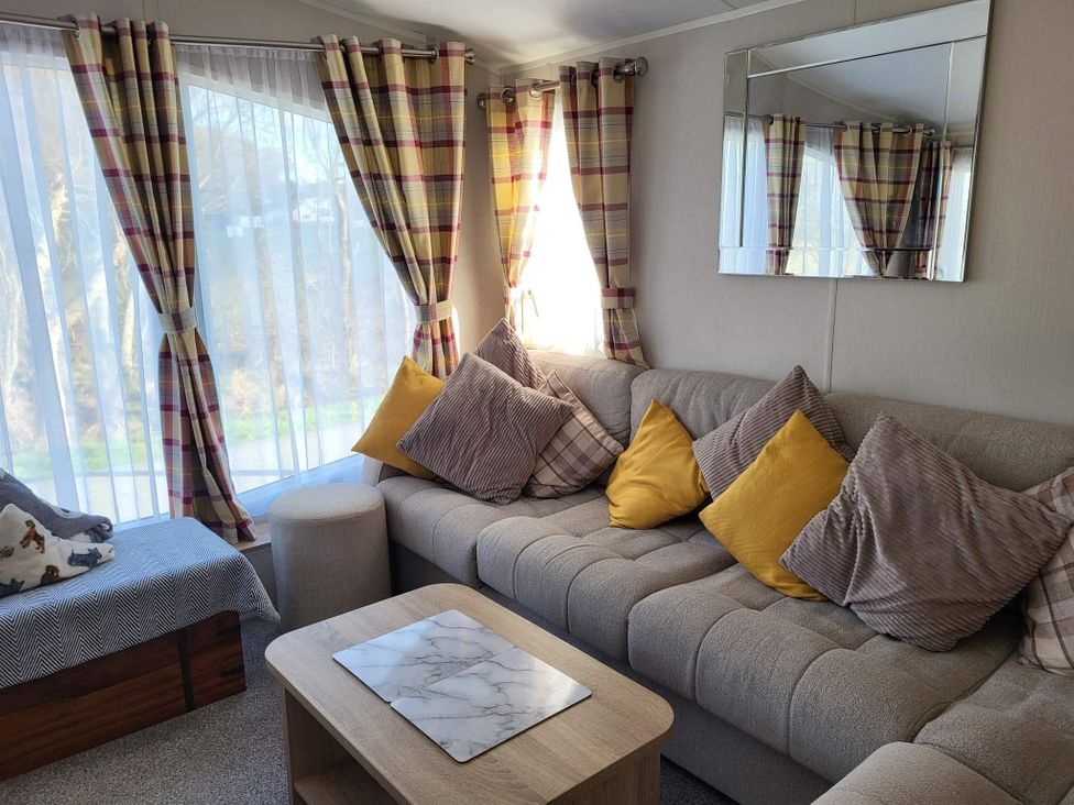 A living room with a sofa and coffee table at Clarach Bay Holiday Village W18 in Aberystwyth