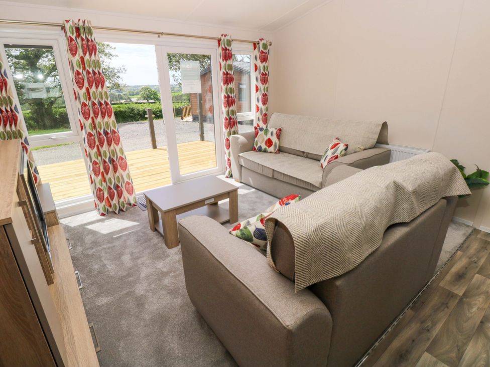 A living room with sofas and a coffee table at Sandpiper in Narberth
