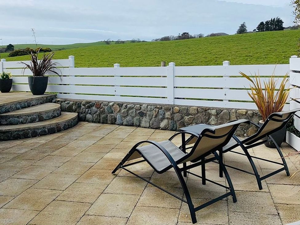An outdoor area with lounge chairs and plants at O7 in Abersoch
