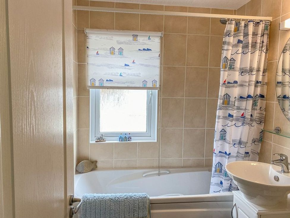 A bathroom with a bathtub and sink at O7 Abersoch