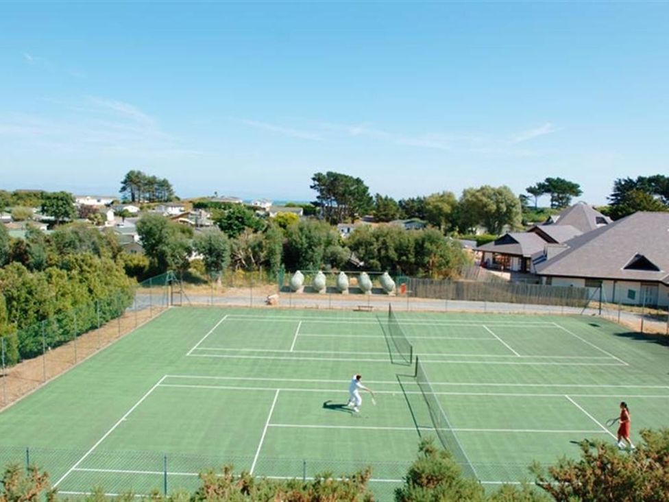 A tennis court with players at O7 in Abersoch