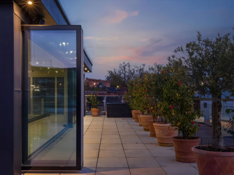An outdoor terrace with plant pots at The Penthouse in Shrewsbury