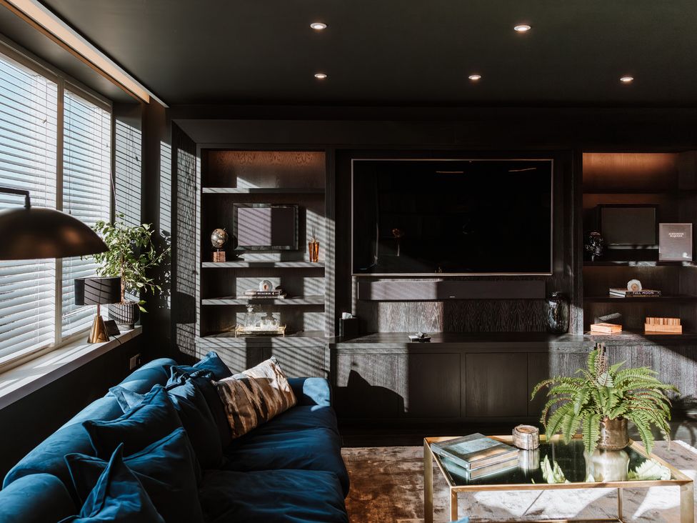 A living room with a television and sofa at The Penthouse in Shrewsbury