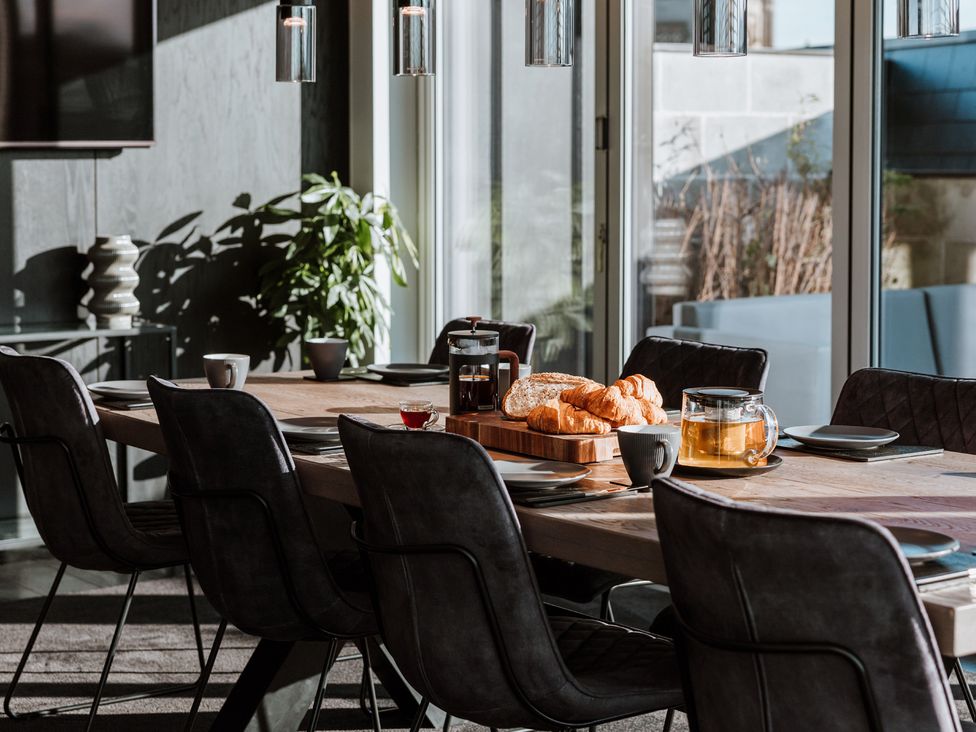 A dining room with a table set for breakfast at The Penthouse in Shrewsbury