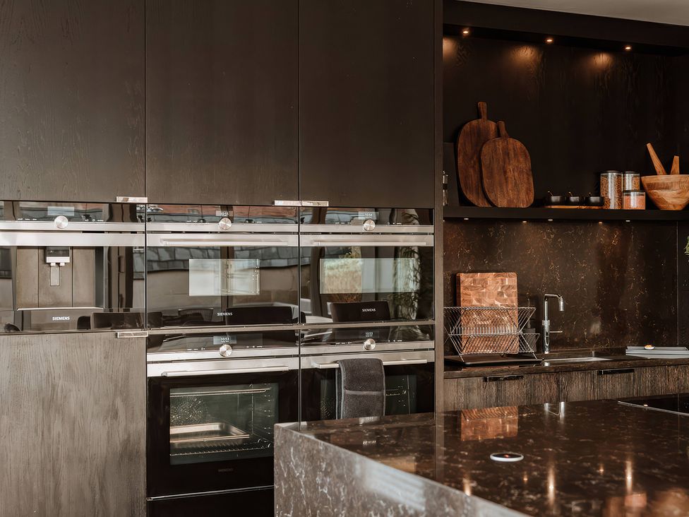 A kitchen with built-in appliances and shelving at The Penthouse in Shrewsbury