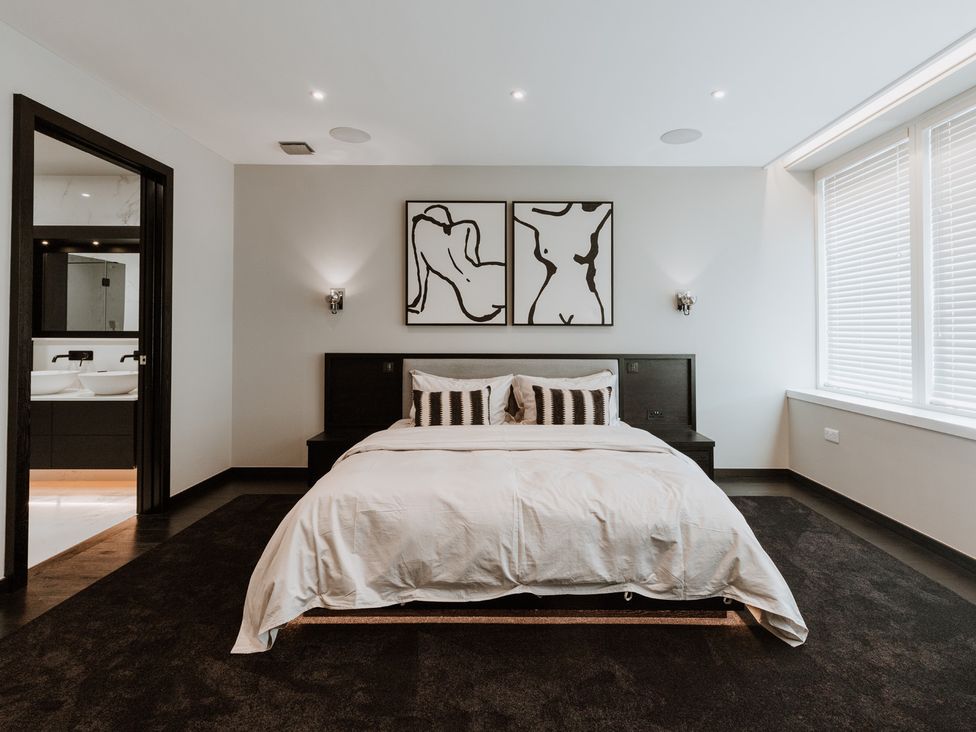 A bedroom with a bed and wall art at The Penthouse in Shrewsbury