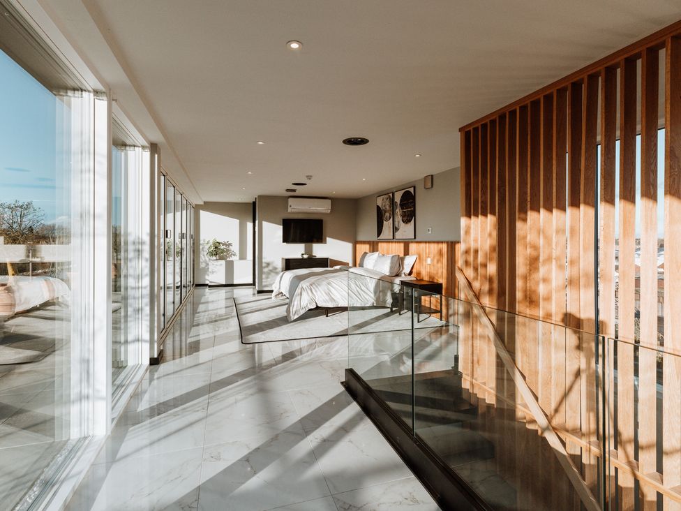 A bedroom with a bed and television at The Penthouse in Shrewsbury