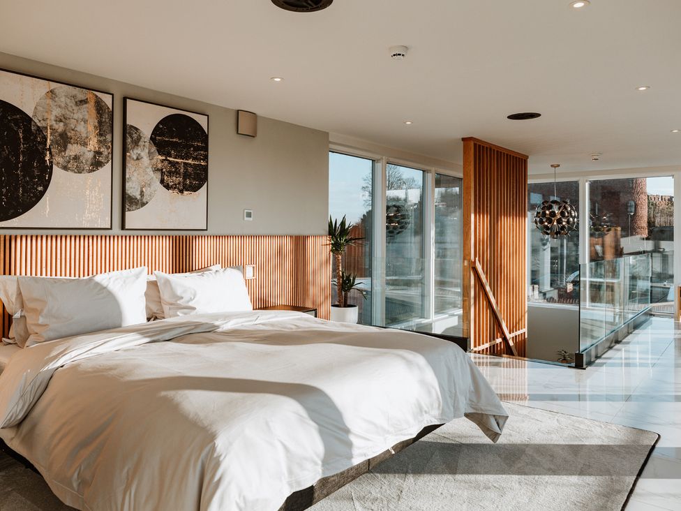 A bedroom featuring a bed and artwork at The Penthouse in Shrewsbury