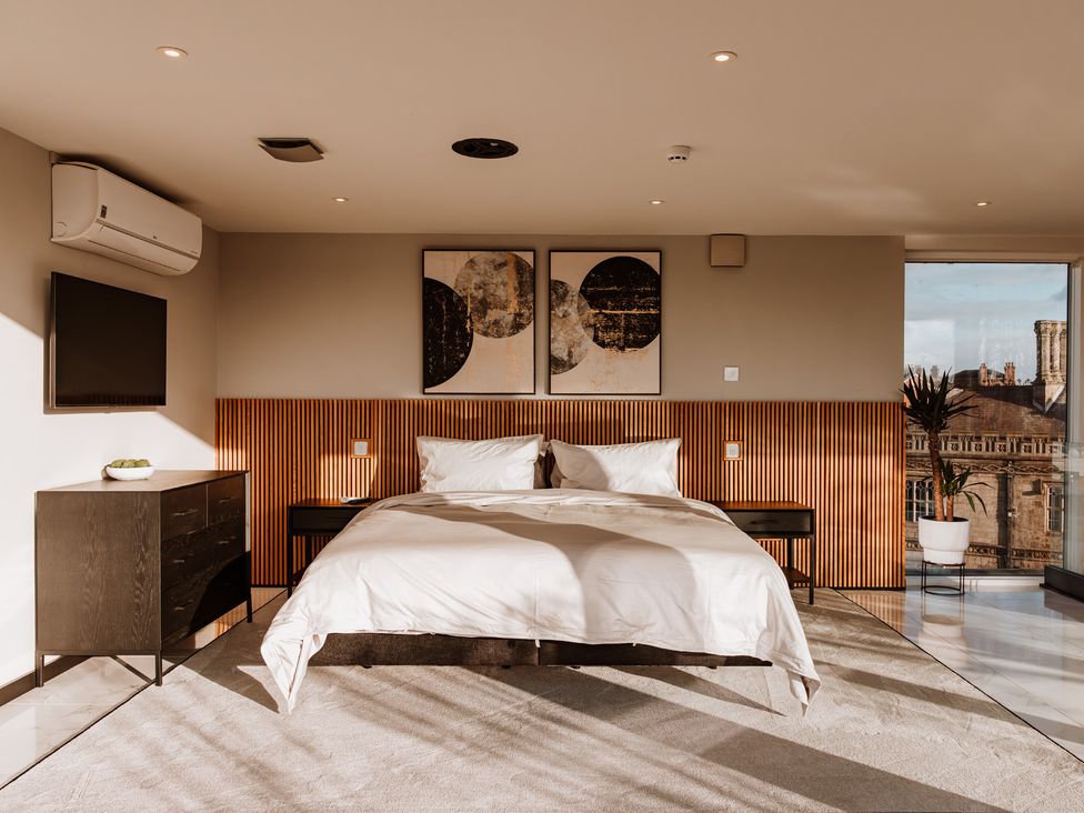 A bedroom with a bed and TV at The Penthouse in Shrewsbury