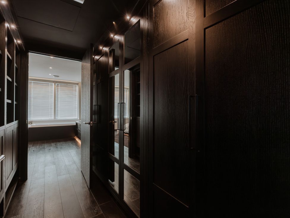 A hallway with closets and a window at The Penthouse in Shrewsbury