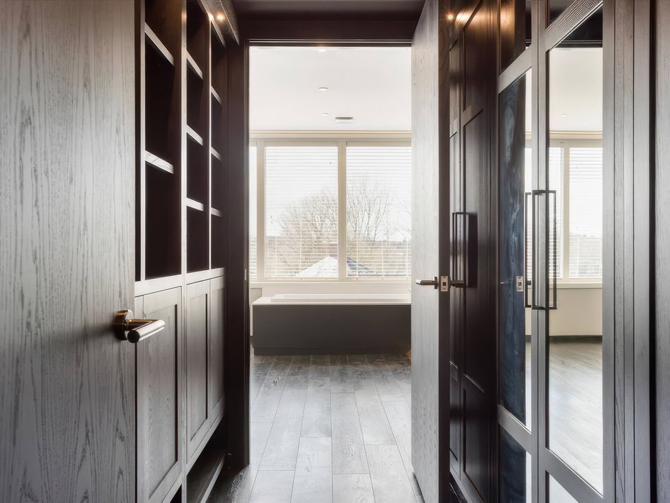 A hallway with bookshelves and windows at The Penthouse in Shrewsbury