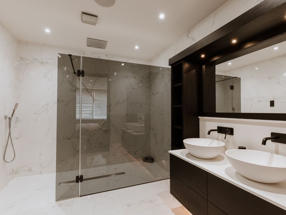 A bathroom with a shower and two sinks at The Penthouse in Shrewsbury