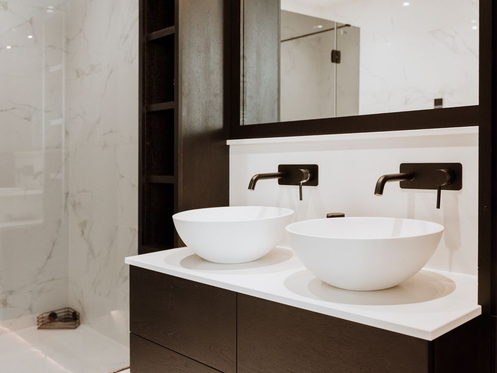 A bathroom with two wash basins and a mirror at The Penthouse in Shrewsbury