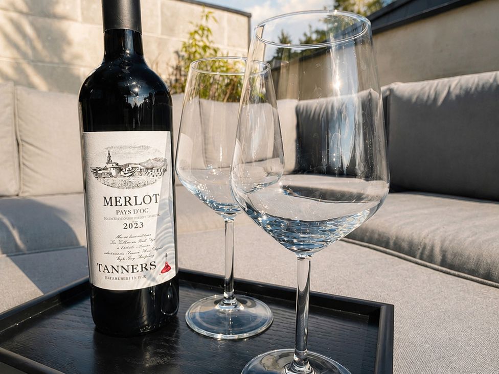 A wine bottle and two glasses on a tray at Luxury two story Penthouse with roof top terrace in Shrewsbury