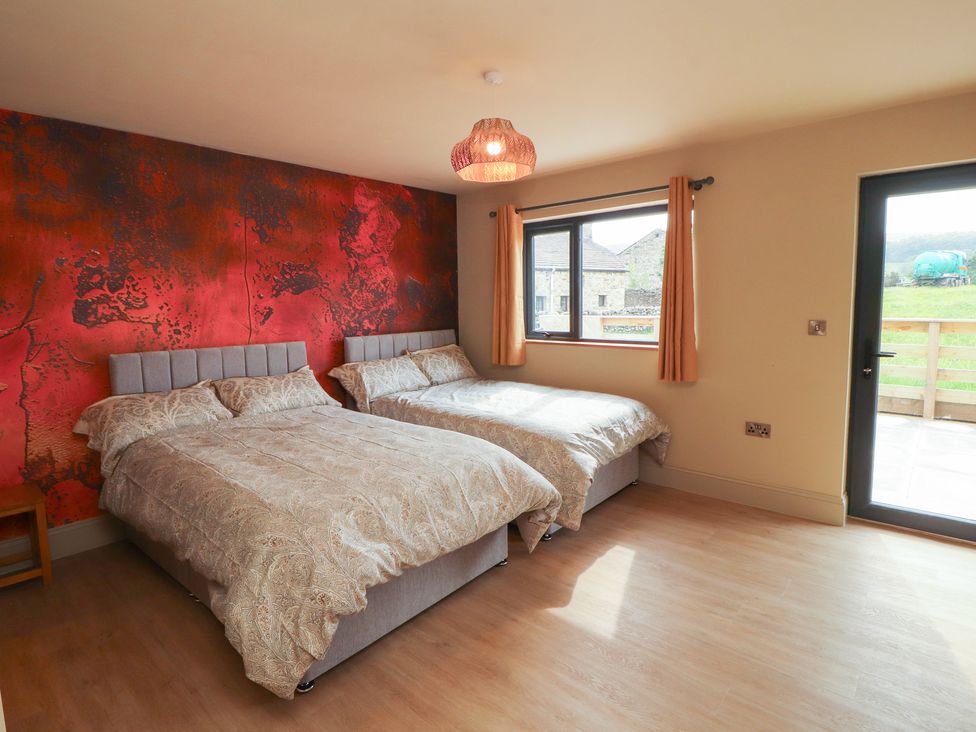 A bedroom with two beds and a window at Beckdale in Settle
