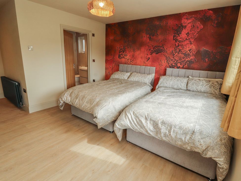 A bedroom with two beds and a radiator at Beckdale in Settle