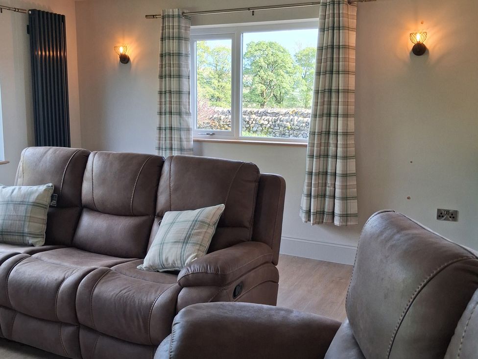 A living room with a sofa and window at Beckdale in Horton-in-Ribblesdale near Settle