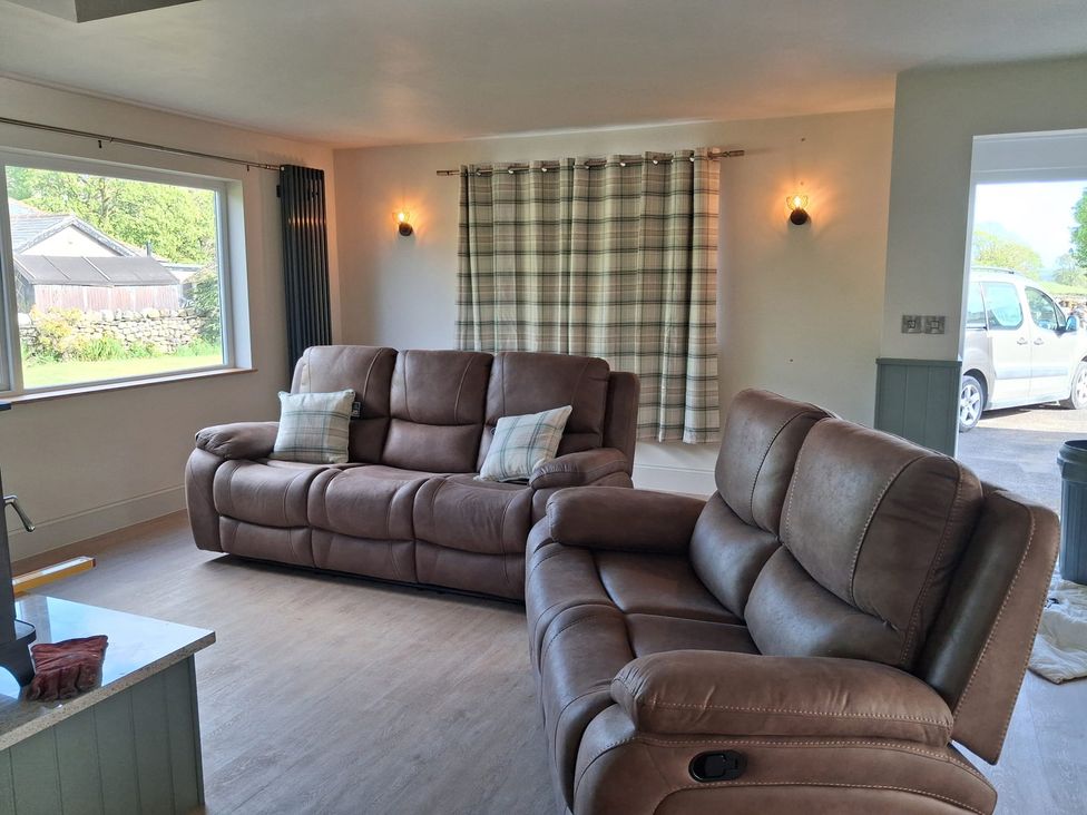 A living room with sofas and a window at Beckdale in Horton-in-Ribblesdale near Settle