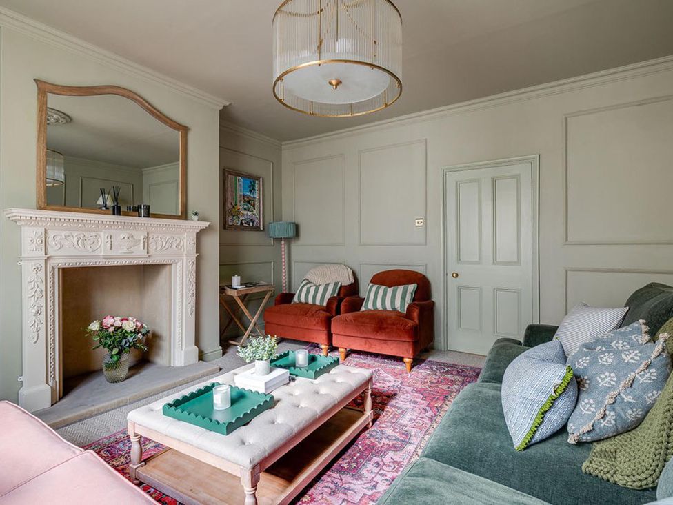 A living room with a fireplace and sofa at Luxury Georgian Townhouse / sleeps 10 / parking