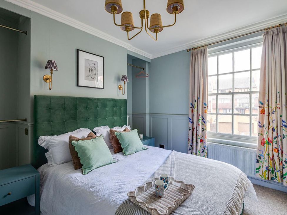 A bedroom with a green bed and a window at Luxury Georgian Townhouse / sleeps 10 / parking