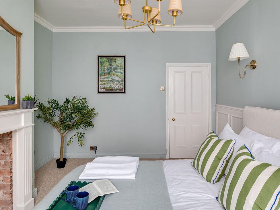 A bedroom with a bed and plant at Luxury Georgian Townhouse / sleeps 10 / parking