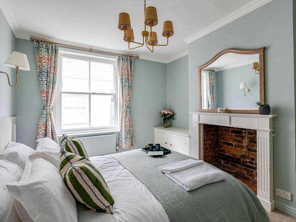 A bedroom with a bed and decorative pillows at Luxury Georgian Townhouse / sleeps 10 / parking