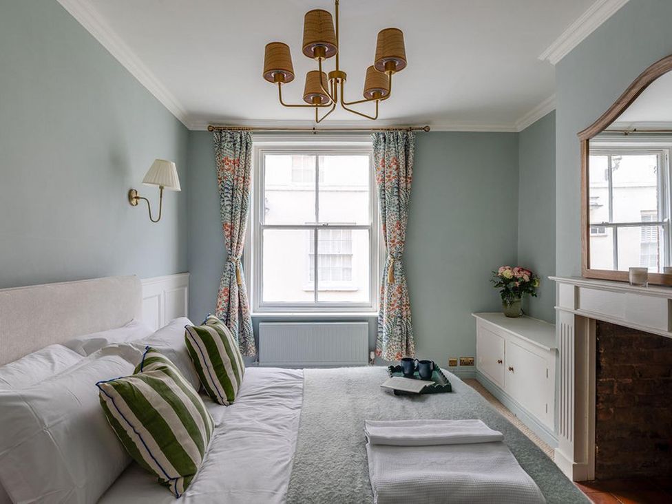 A bedroom with a bed and window at Luxury Georgian Townhouse / sleeps 10 / parking