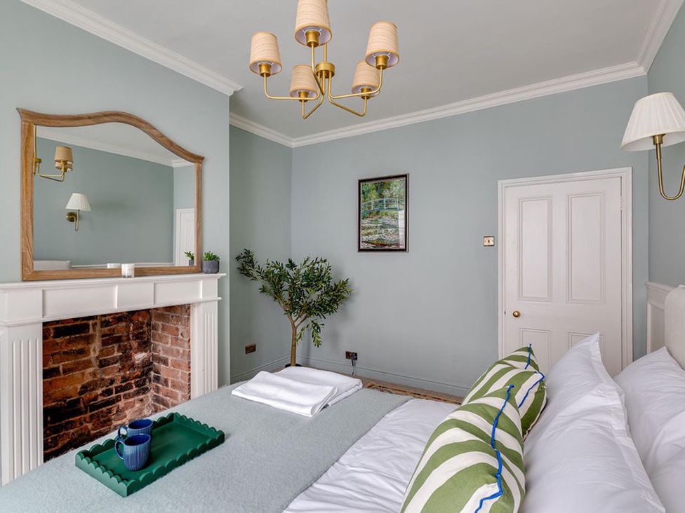 A bedroom with a bed and a mirror at Luxury Georgian Townhouse / sleeps 10 / parking