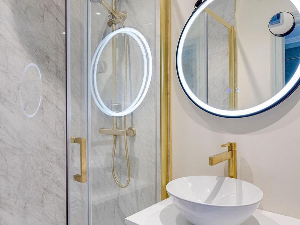 A bathroom with a shower, sink, and mirror at Luxury Georgian Townhouse / sleeps 10 / parking