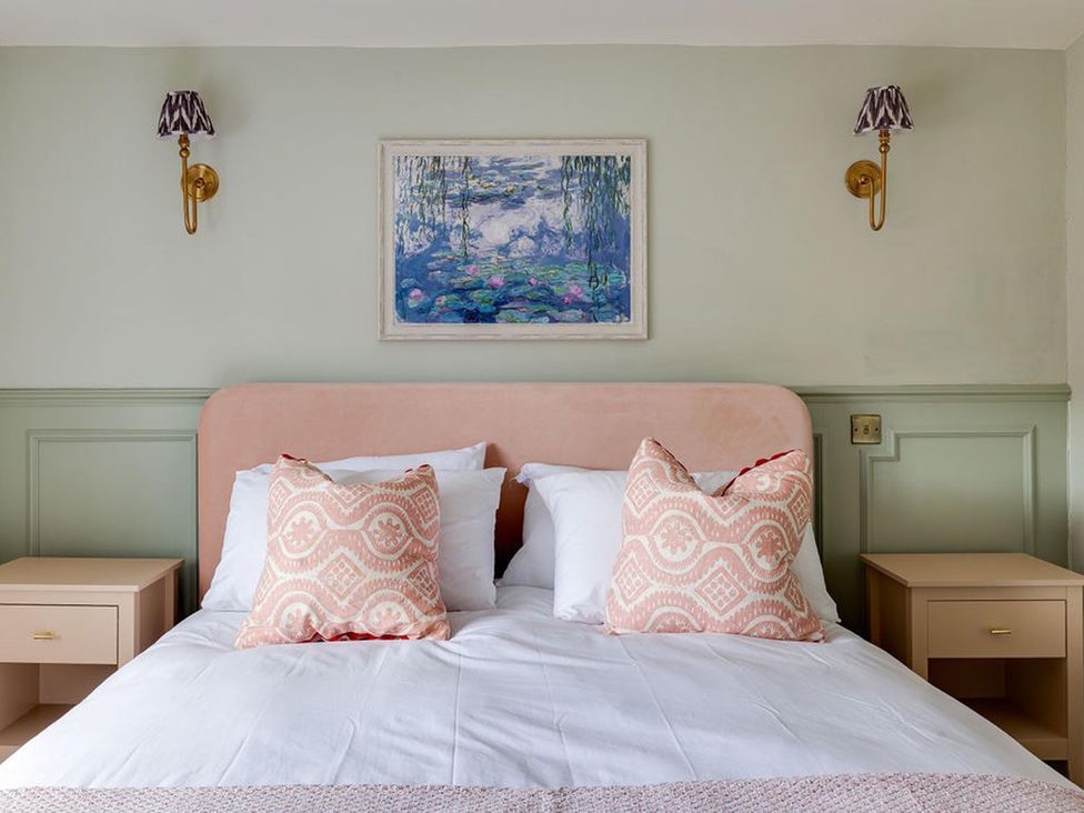 A bedroom with a bed, nightstands, and wall art at Luxury Georgian Townhouse / sleeps 10 / parking