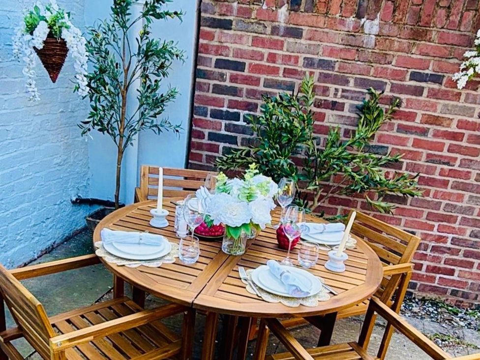 A dining setup with a table and chairs at Luxury Georgian Townhouse / sleeps 10 / parking