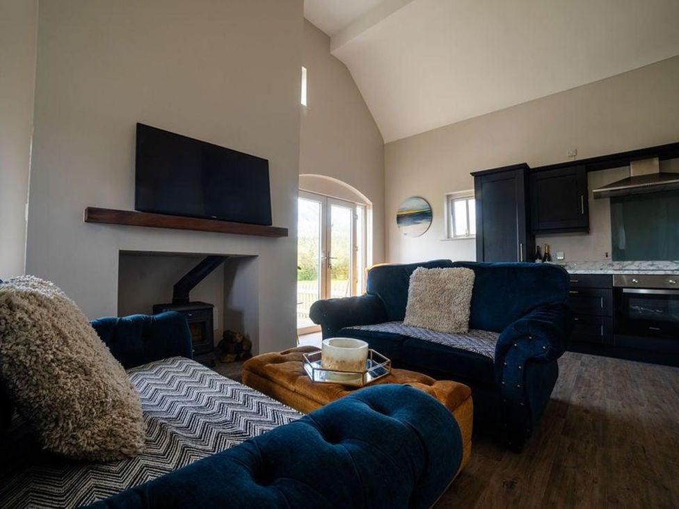 A living room with a sofa and television at Cottage, 3 Bed, Sleeps 7, Free Parking