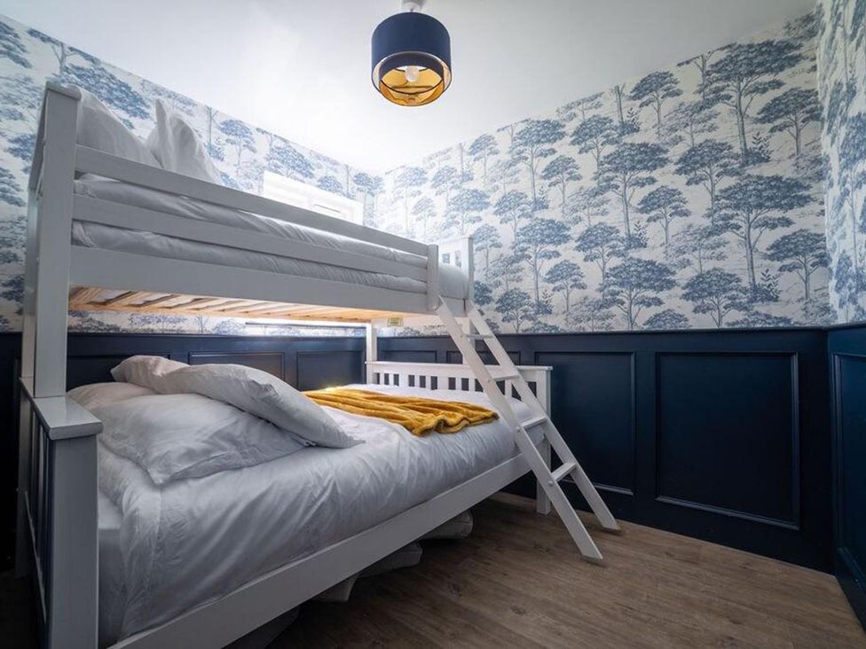 A bedroom with a bunk bed and a blanket at Cottage, 3 Bed, Sleeps 7, Free Parking