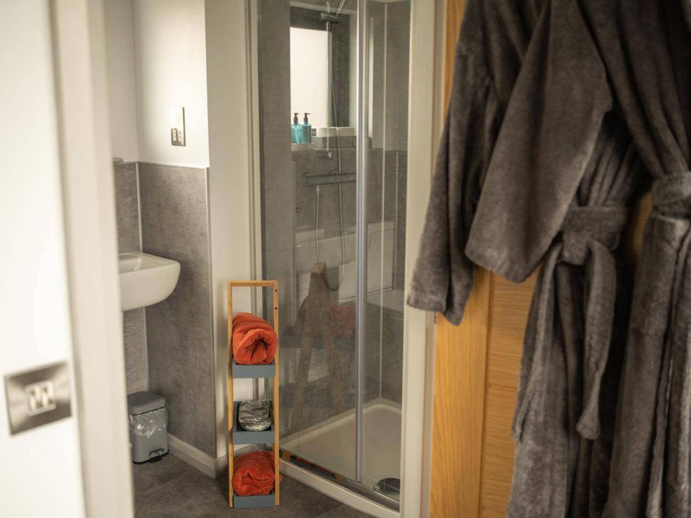 A bathroom with a sink and shower at Migdale Heights - Luxury Cabins in The Highlands