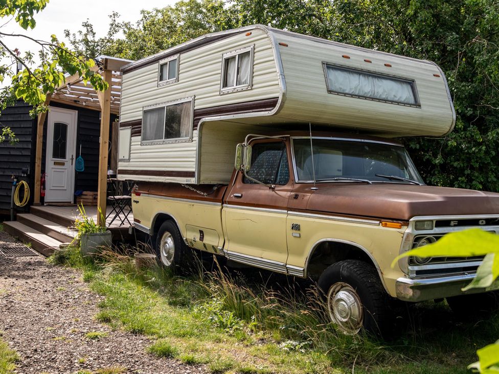 A camper mounted on a truck with steps leading to a door at 1 Bed Vehicle Luxury Camper -Hot Tub, Pets - Willy, Mill Lane Farmhouse near Burgh Le Marsh