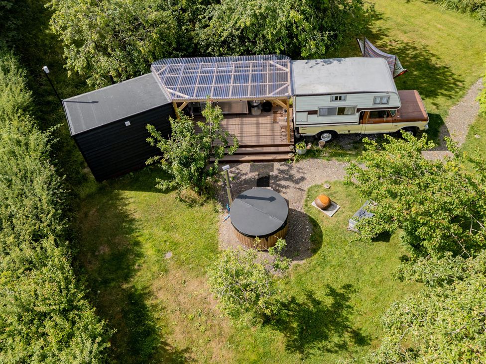 A camper with a deck and hot tub at 1 Bed Vehicle Luxury Camper -Hot Tub, Pets - Willy, Mill Lane Farmhouse near Burgh Le Marsh