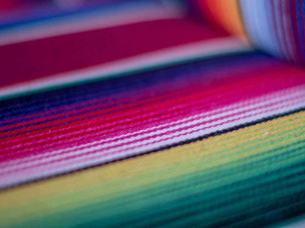 A close-up view of a colorful striped textile fabric