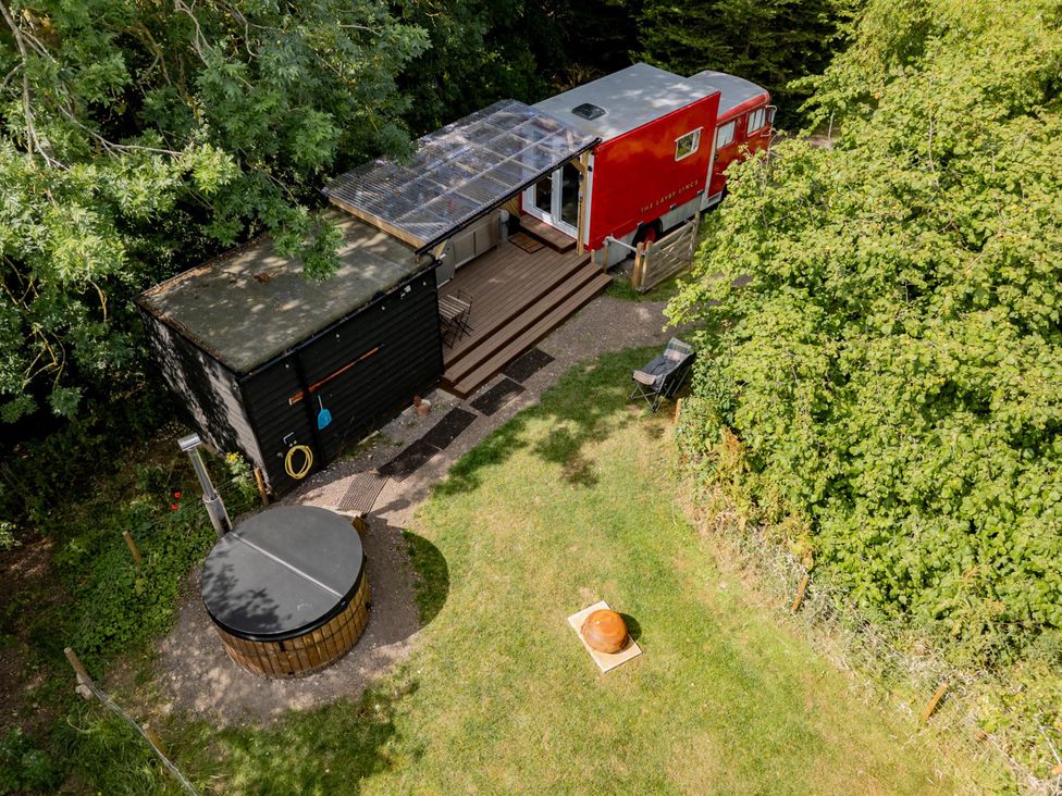 An outdoor area with a wooden hot tub and decking at Sleeps 2 -Private Garden -Pets Ok -Hot Tub -Dennis