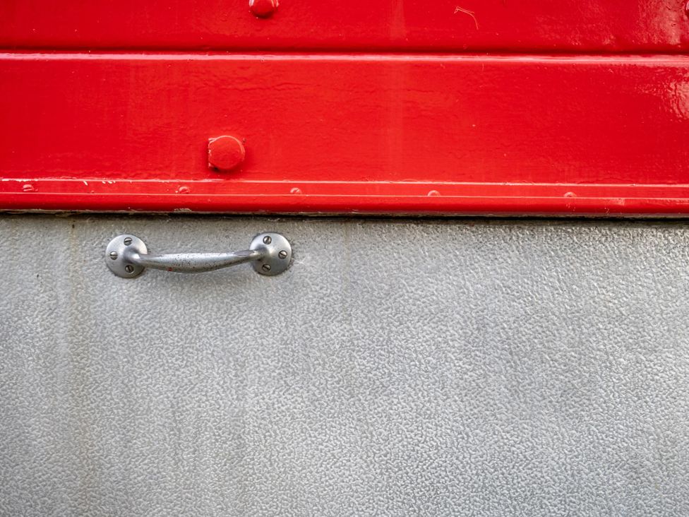 A red and grey surface with a metal handle
