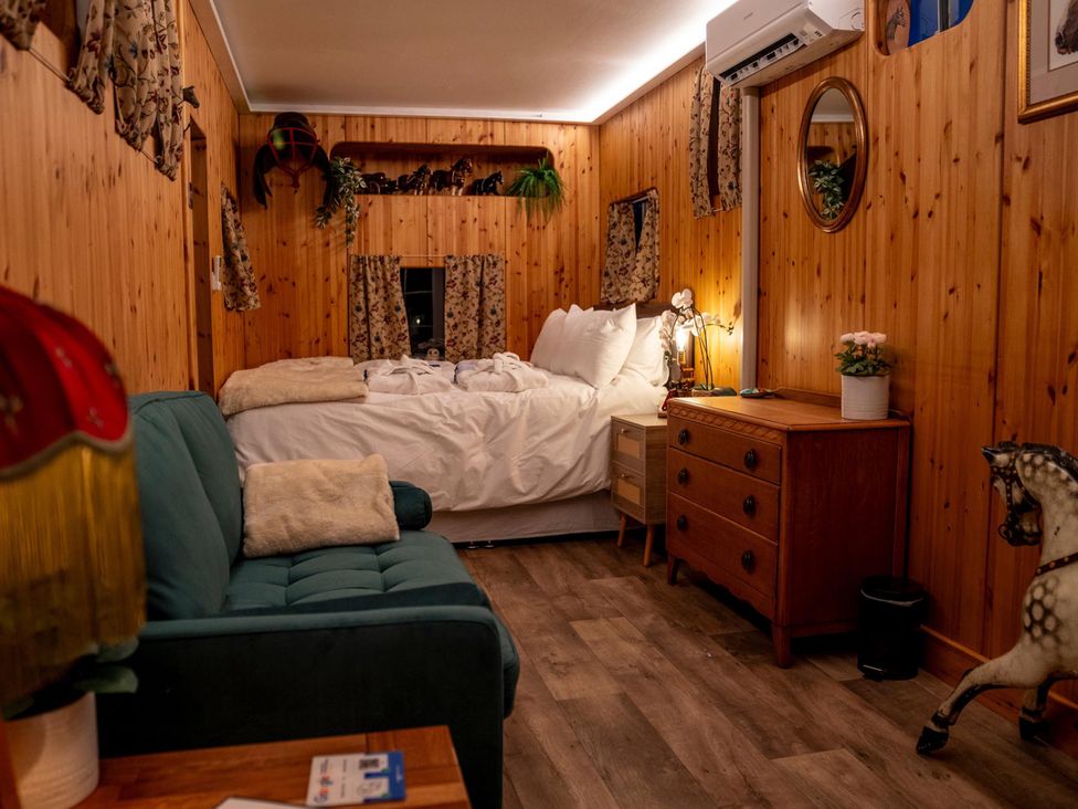 A bedroom with a bed and wooden furniture at 1 Bed -Private Garden -Hot Tub -Pets Ok - Gee Gee