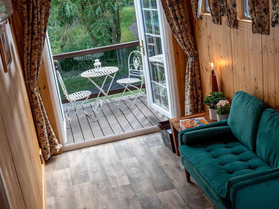 A living room with a sofa and a table at 1 Bed -Private Garden -Hot Tub -Pets Ok - Gee Gee