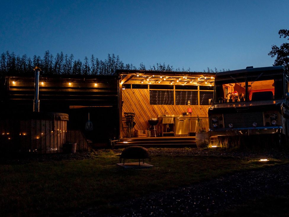 An outdoor kitchen with seating and hot tub at Sleeps 2 -Pets Welcome -Private Hot Tub -Alabama