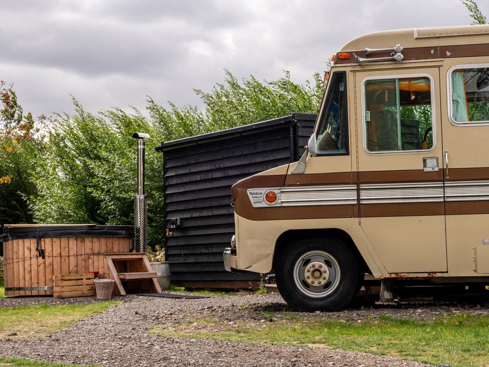 A camper van and hot tub in an outdoor area at Sleeps 2 -Pets Welcome -Private Hot Tub -Alabama