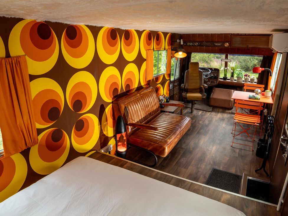 A living room with a sofa and table at Sleeps 2 -Pets Welcome -Private Hot Tub -Alabama