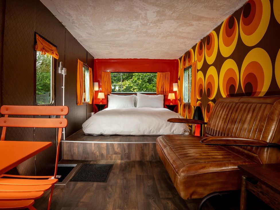A bedroom with a bed and seating area at Sleeps 2 -Pets Welcome -Private Hot Tub -Alabama