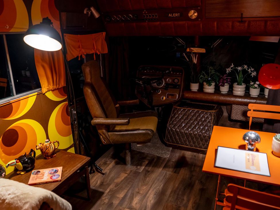 A living area with a chair and table at Sleeps 2 -Pets Welcome -Private Hot Tub -Alabama