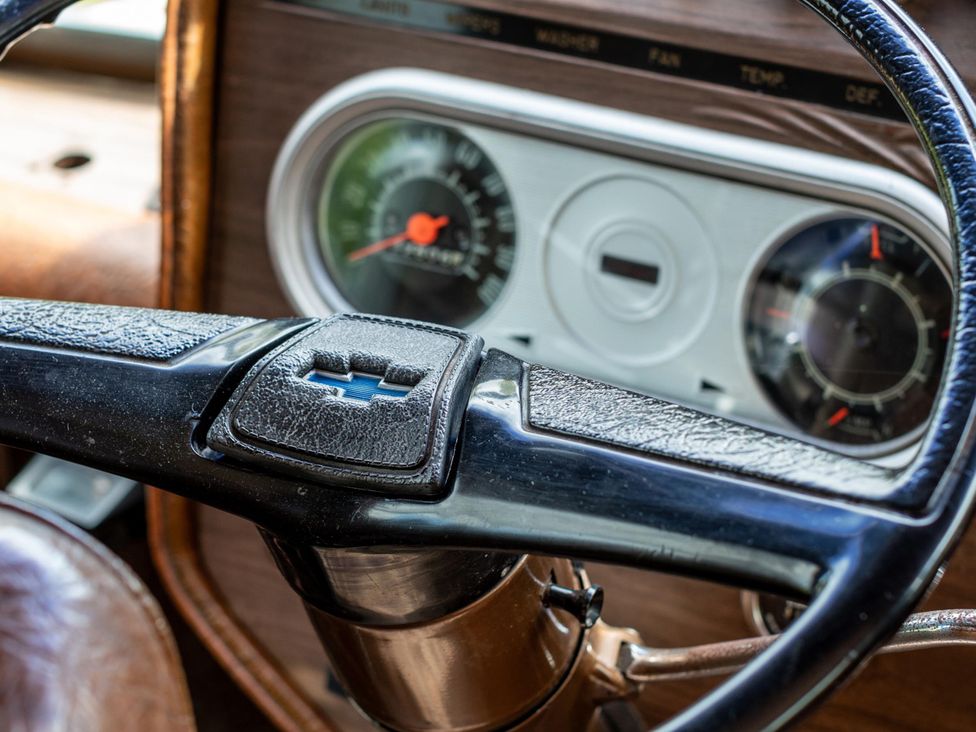 A steering wheel and dashboard in a car interior
